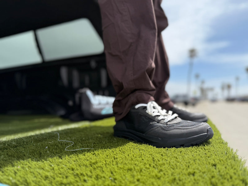 Best travel sneakers for active days – CDNCE Goth Black shoes on grass