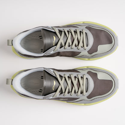 Pair of gray sneakers with white soles on a light gray background