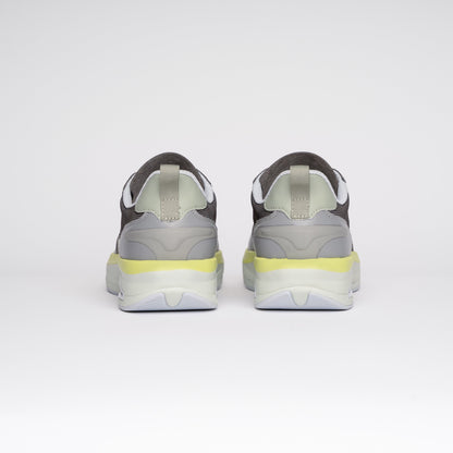 Gray sneakers with yellow accents on a white background