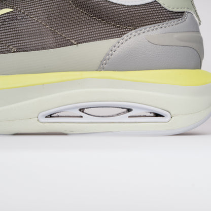 Close-up of a gray and yellow sneaker on a white background