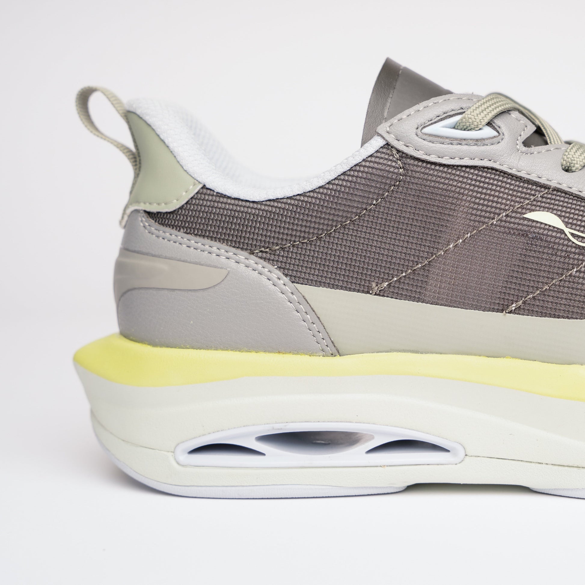 Gray and yellow sneaker on a white background